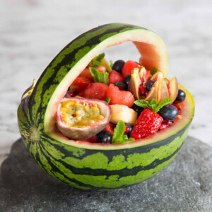 close up shot of watermelon basket on slate with marble background