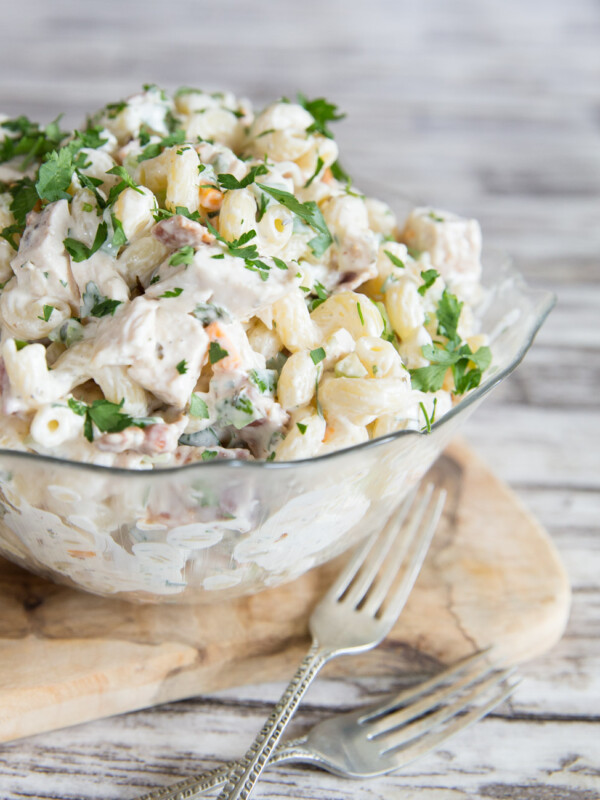 Chicken Bacon Ranch Pasta Salad with fresh parsley in a glass bowl