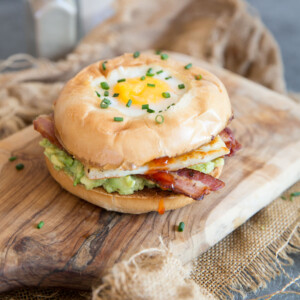 egg in a hole breakfast bagel with chilli jam dripping out