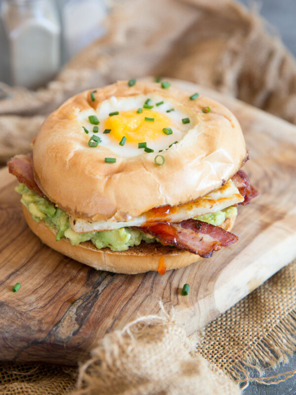 egg in a hole breakfast bagel with chilli jam dripping out