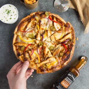 Smokey BBQ Chicken Pizza overhead with wedges and sour cream and chive dip