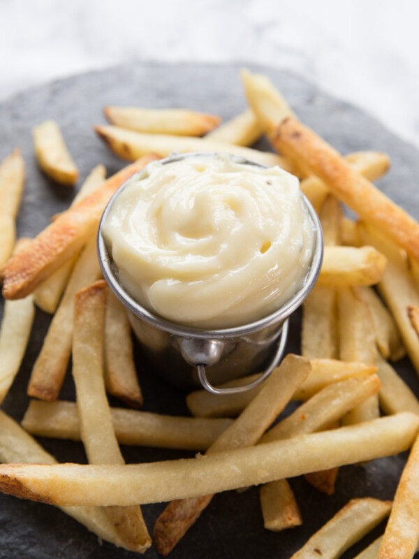 small silver pot of aioli with fries surrounding it