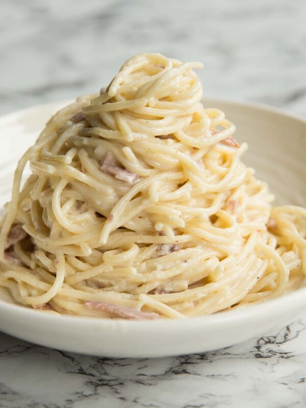 Cream Cheese Pasta served on a curved white plate on a marble surface