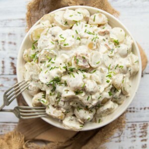 overhead shot of bowl of potato salad with two silver forks resting on it