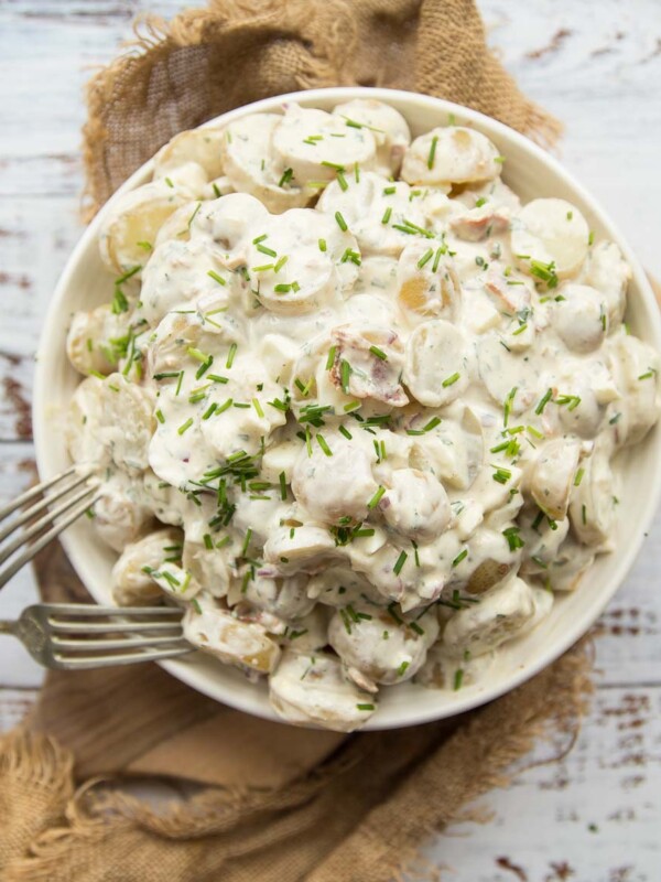 overhead shot of bowl of potato salad with two silver forks resting on it