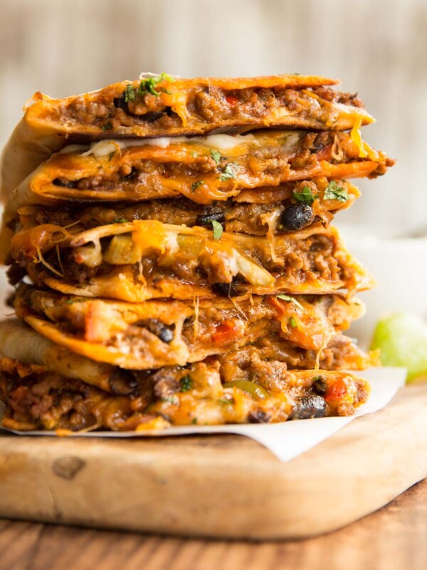 quesadillas stacked on top of each other with filling slightly pouring out