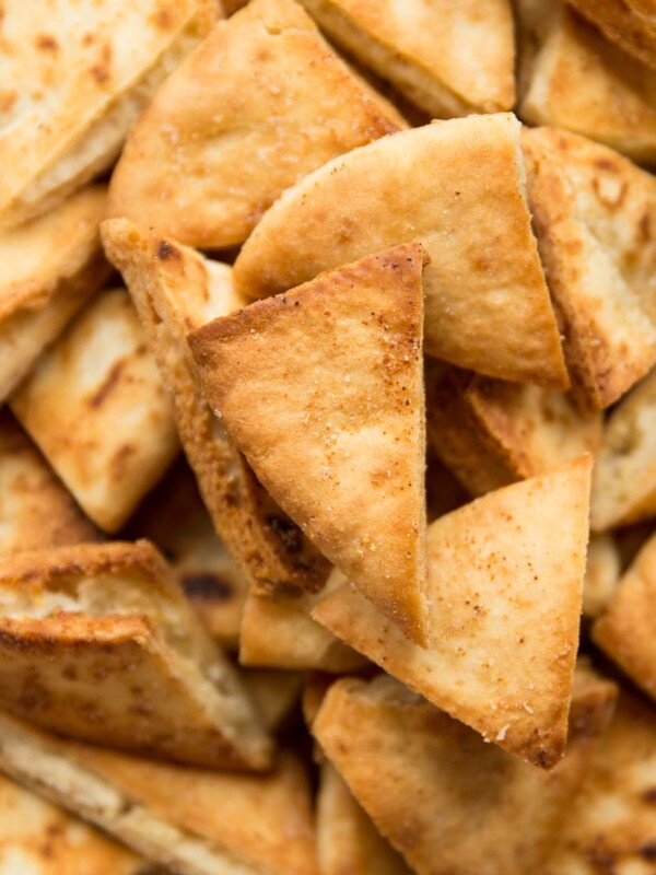 overhead shot of bowl of pita chips, focus on one