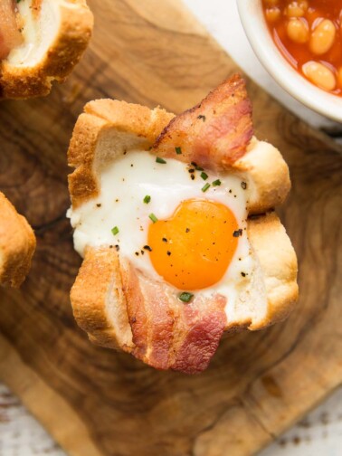 overhead shot of egg toast cup on wooden board