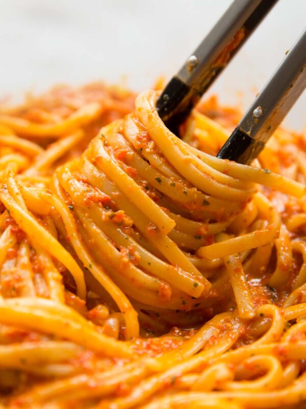 pasta tongs twirling in a bowl of linguine