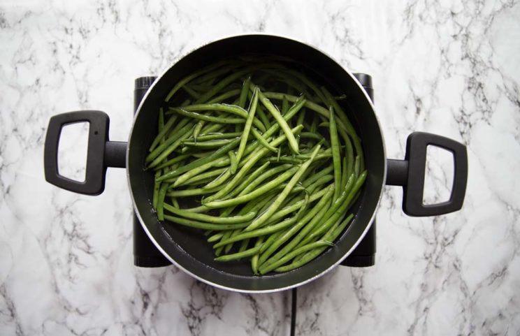 green beans in a pot of water ready to boil