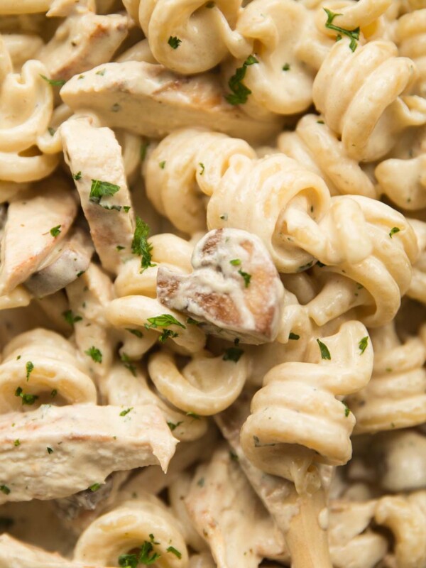 overhead shot of chicken and mushroom pasta with parsley to garnish