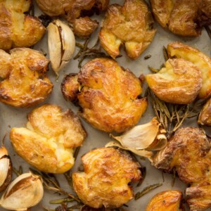 overhead of smashed potatoes on baking tray fresh out the oven