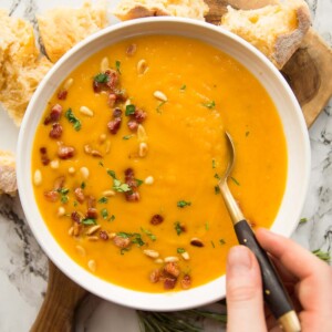 overhead shot of soup in a bowl with spoon digging in