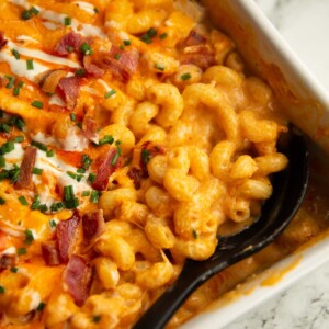 close up shot of serving spoon digging in to baked buffalo chicken mac and cheese fresh out the oven