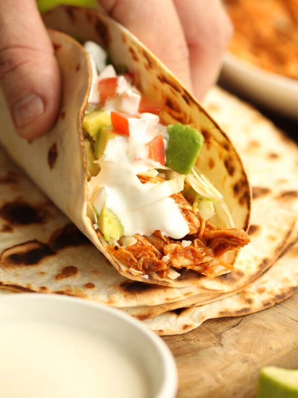 closeup of turkey taco with ingredients blurred in background