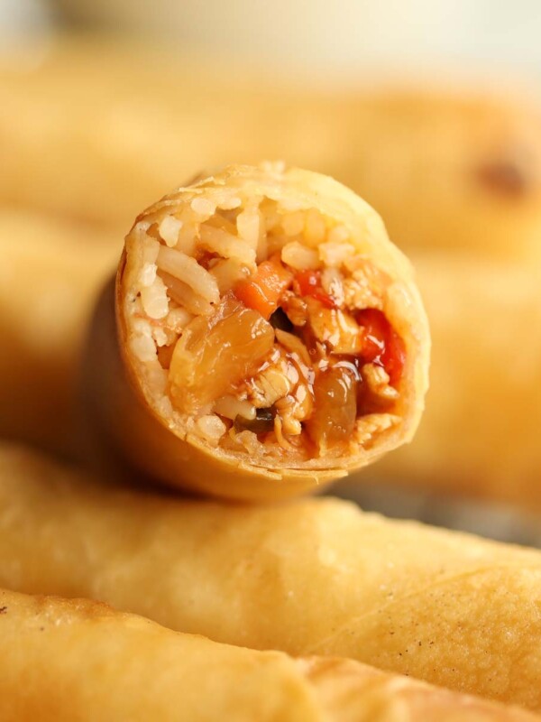 closeup shot of sweet and sour chicken filling inside spring roll