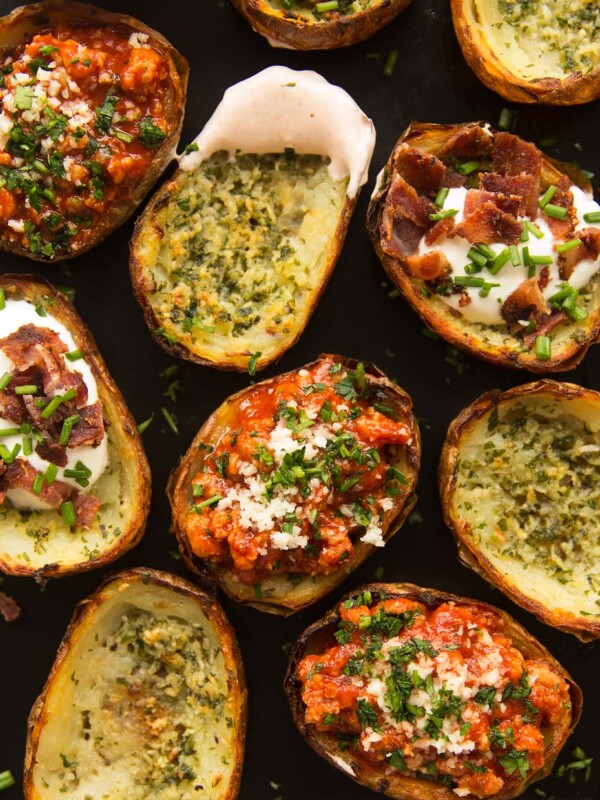 overhead shot of potato skins with fillings on oven tray