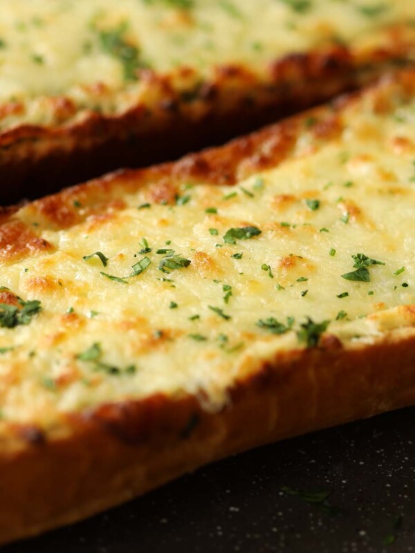 cheesy garlic bread fresh out the oven garnished with parsley