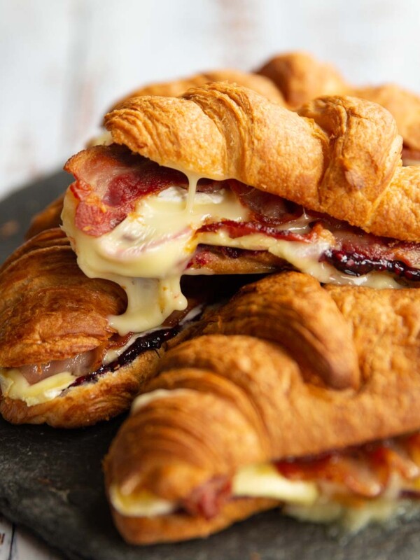 croissants stacked on one another with brie dripping off of top one