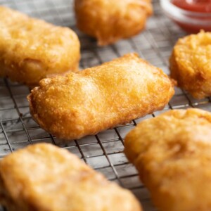 fritters fresh out the fryer on wire rack with ketchup blurred in background