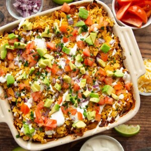 overhead shot of taco pasta with taco ingredients on top in casserole dish