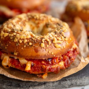 closeup shot of bagel with fillings spilling out on slate