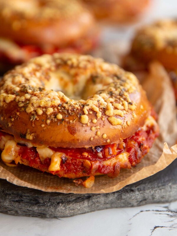 closeup shot of bagel with fillings spilling out on slate