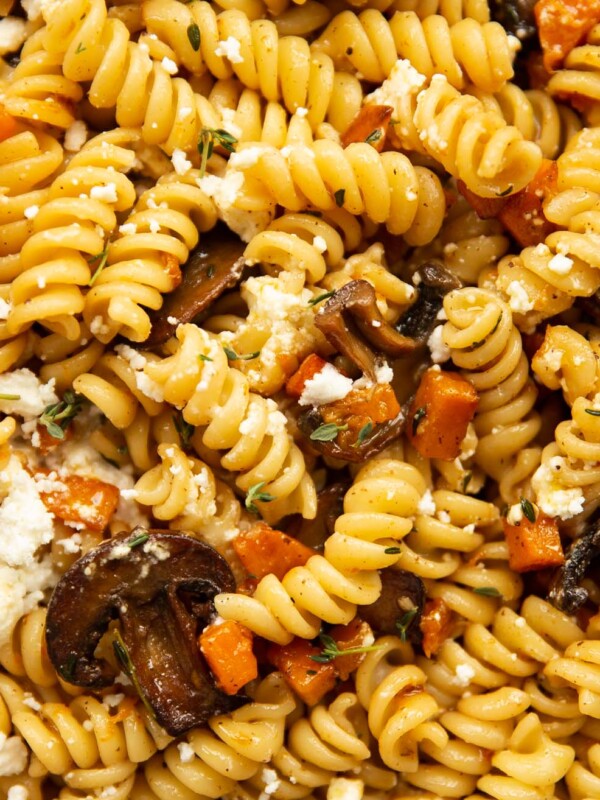 overhead shot of pasta in skillet sprinkled with goats cheese