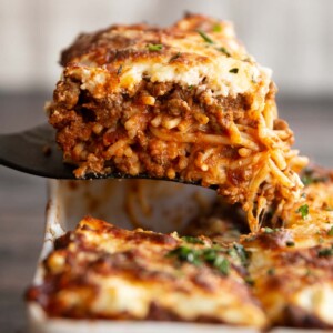 spatula lifting spaghetti from casserole dish