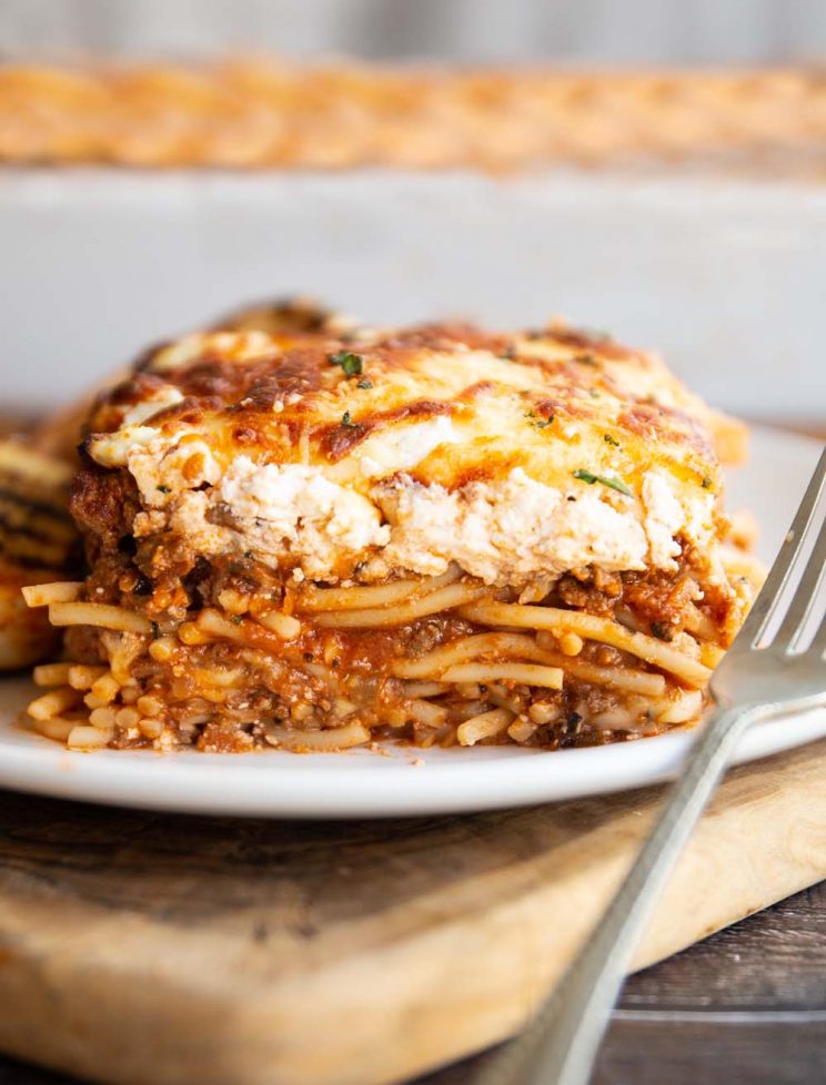 spaghetti bake served on white plate with silver fork resting on it