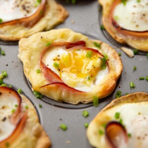 closeup shots of egg cups in muffin tin garnished with chives