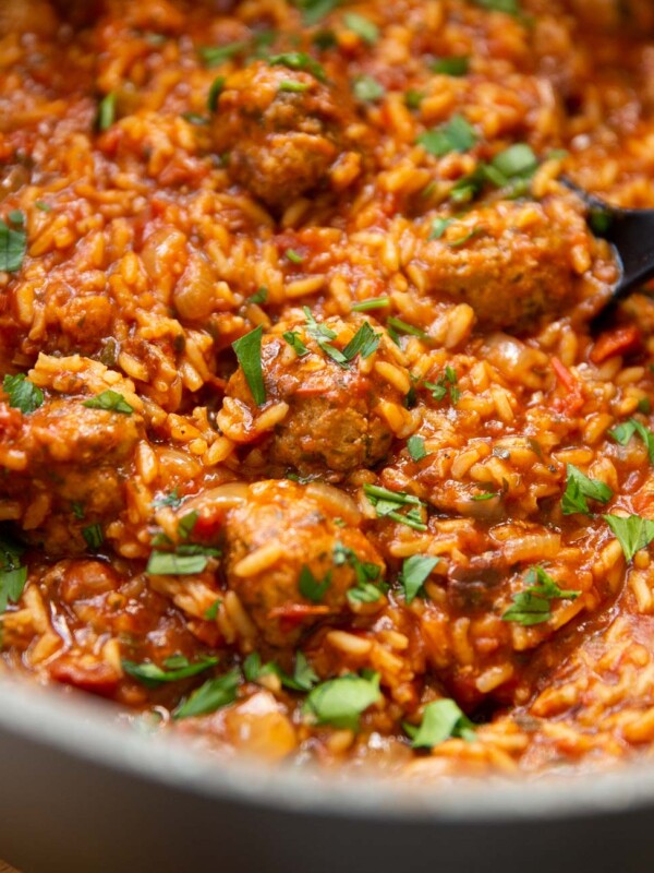 closeup shot of meatballs and rice in pot, focus on meatball in centre