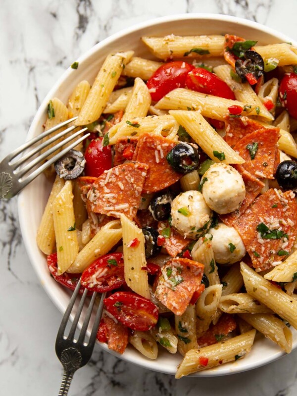 overhead shot of pasta in white bowl with two forks resting