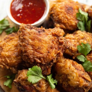 closeup shot of chicken on wooden board with board blurred in background