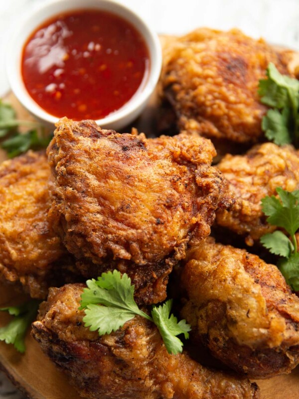 closeup shot of chicken on wooden board with board blurred in background