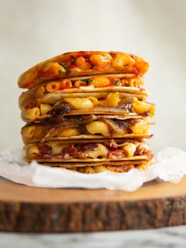 6 quesadillas stacked on each other on wooden block