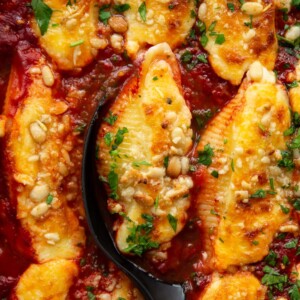 overhead shot of shells fresh out the oven with serving spoon digging in