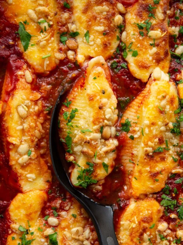 overhead shot of shells fresh out the oven with serving spoon digging in