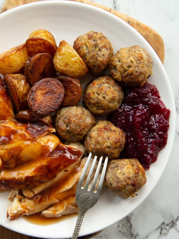 overhead shot of small roast dinner on white plate with stuffing balls