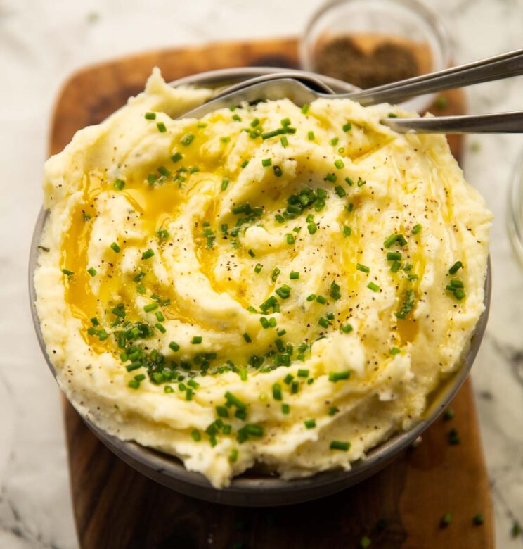 Boursin mash served in bowl with melted butter and chives