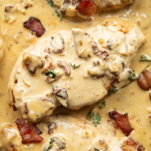 overhead shot of chicken breasts in creamy bacon sauce in skillet