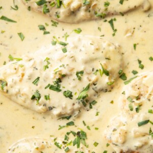 overhead shot of chicken in skillet garnished with tarragon