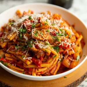 pasta served in large white bowl on wooden board