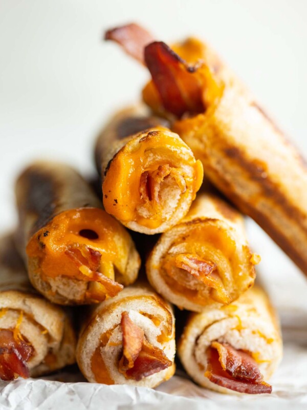 close up shot of roll ups stacked on each other on parchment paper