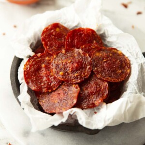 pepperoni chips in parchment paper in mini cast iron skillet