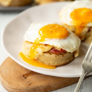 two madame crumpets on white plate on small wooden board with silver fork