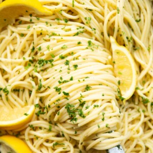 close up overhead shot of lemon pasta and tongs in pan