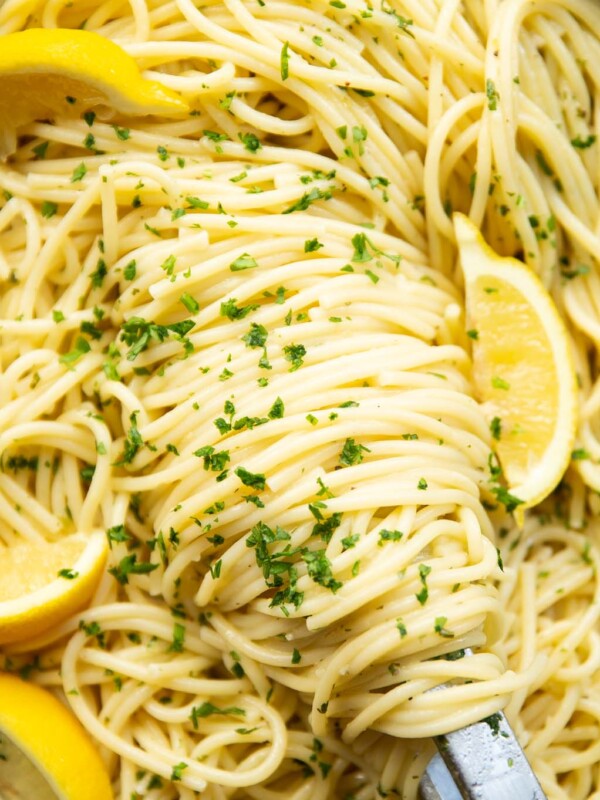 close up overhead shot of lemon pasta and tongs in pan