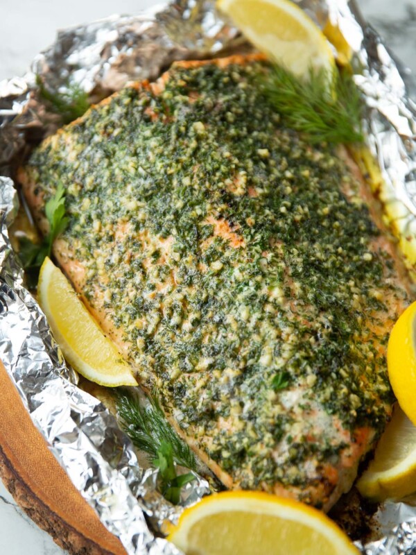 baked salmon wrapped in foil fresh out the oven garnished with lemon wedges