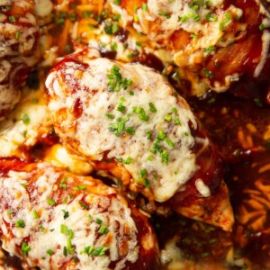 close up overhead shot of hunters chicken in skillet garnished with chives